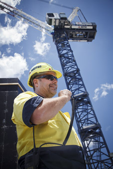 construction photographer brisbane worker on radio to crane operator large
